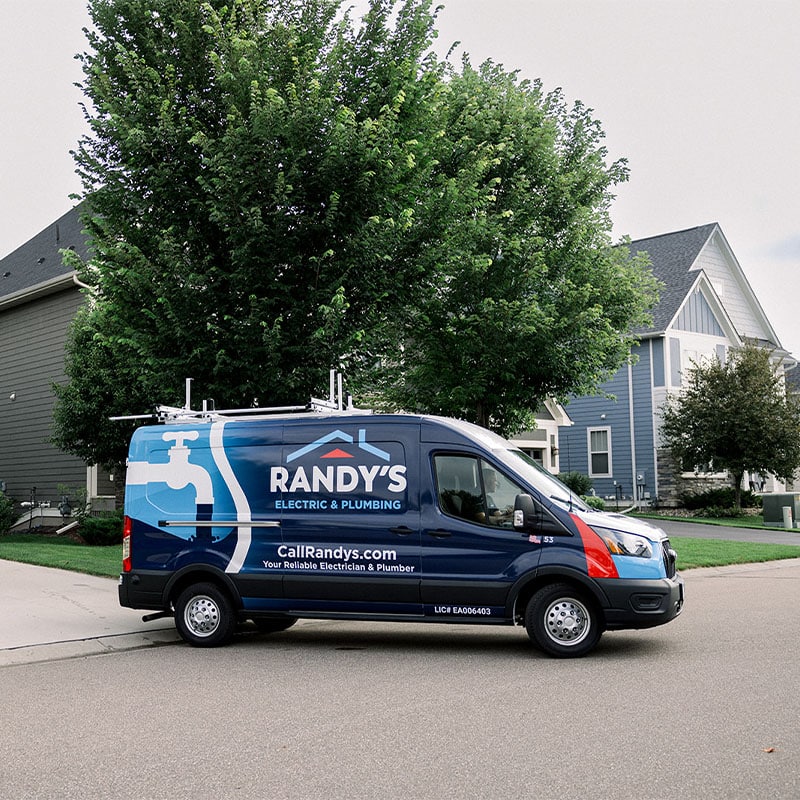 Summit Electric & Plumbing van parked near suburban homes.