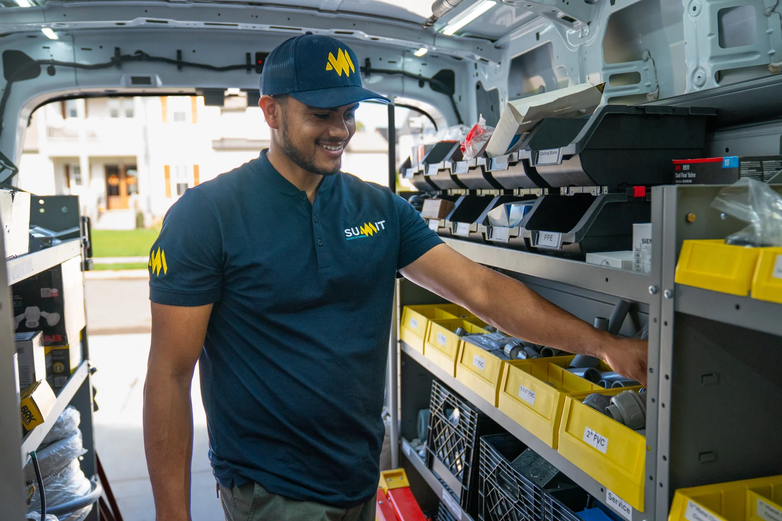Summit electrician grabbing parts from a fully stocked service van