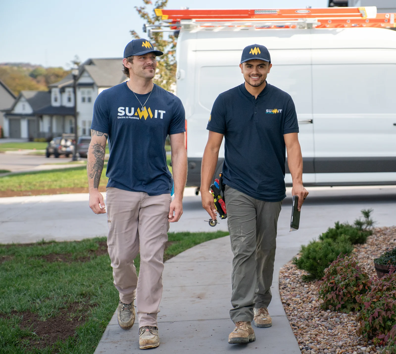Summit Electric & Plumbing electricians walking up to a Middle Tennessee home