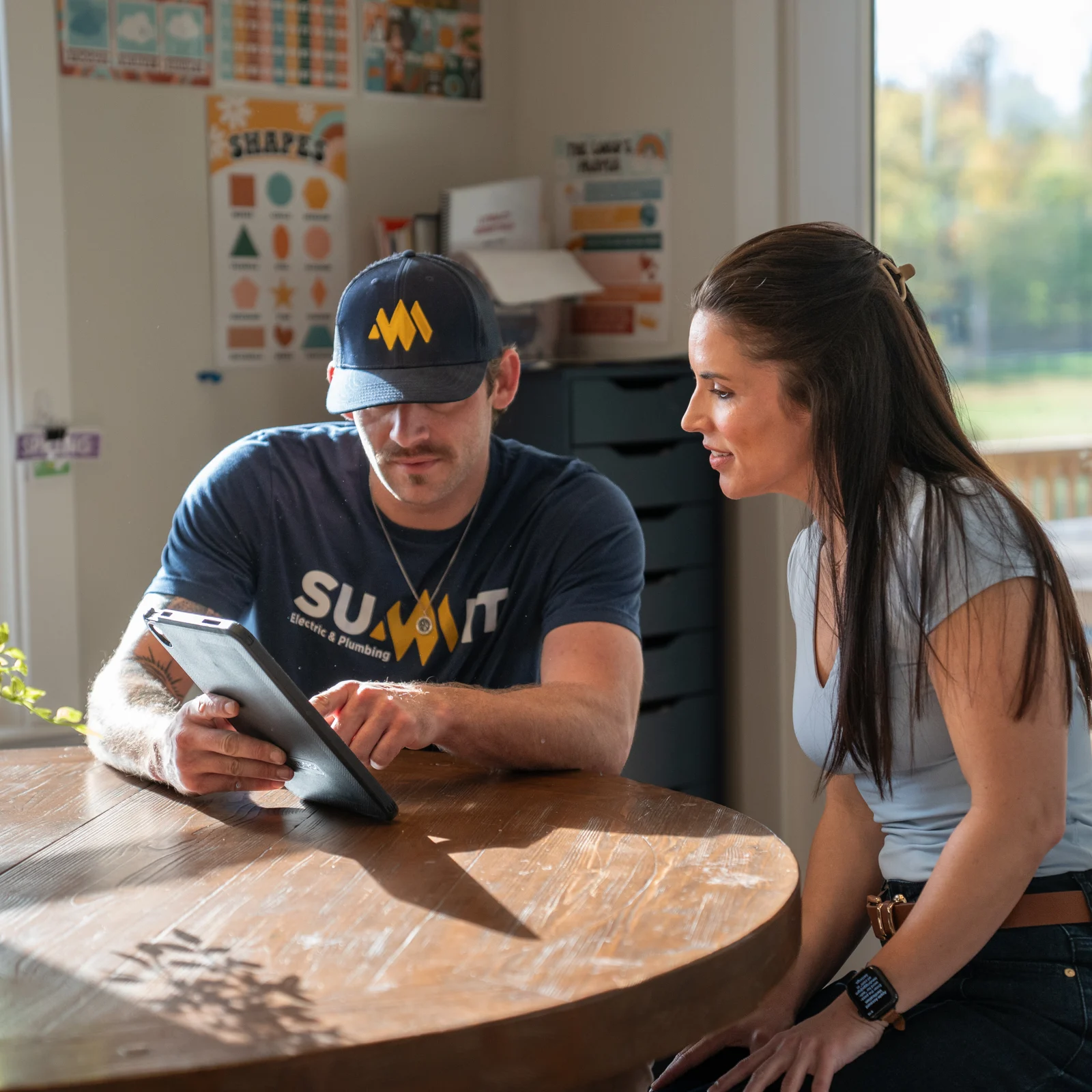 Summit electrician showing upfront pricing on a tablet